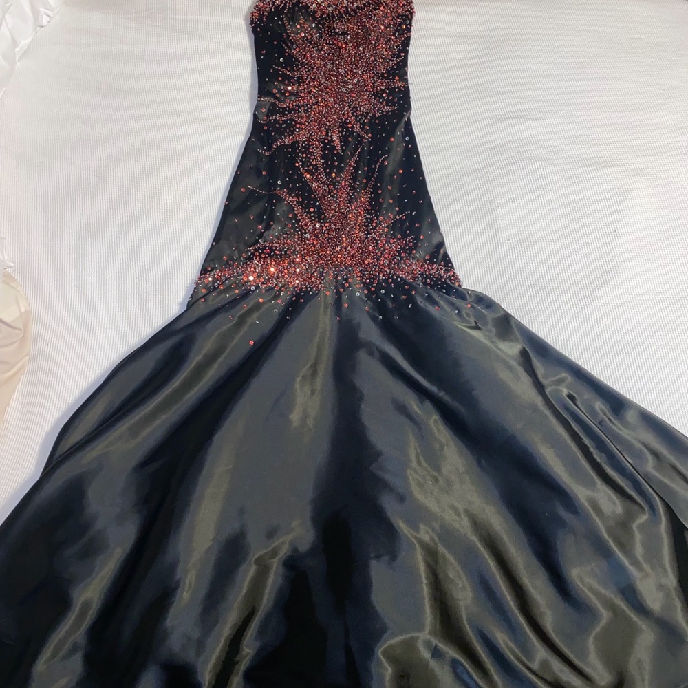 Black prom/pageant dress with red and silver bedding and sequin.